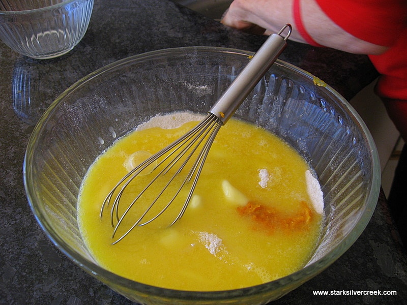 In a bowl, combine melted butter, eggs, orange juice, grated peel, sugar and flour. Beat until smooth (a handmixer here does wonders or you can use an old-fashioned wisk).