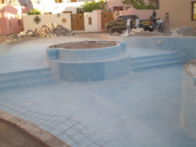 swimmingpool The tile work on the pool seems near complete. Will be beautiful when filled with water. I wonder if they will put the tree back in the center circle. I hope so as I think it will make for a dramatic effect.