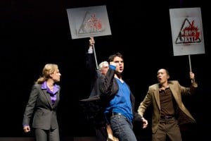 Yellow Face 6 TM Marcus "Gee" Dahlman (Thomas Azar, center) leads protestors (Amy Resnick, left, Howard Swain, center back, and Francis Jue, right) supporting Asian American rights in the Bay Area premiere of YELLOW FACE at TheatreWorks. Photo Credit: Tracy Martin