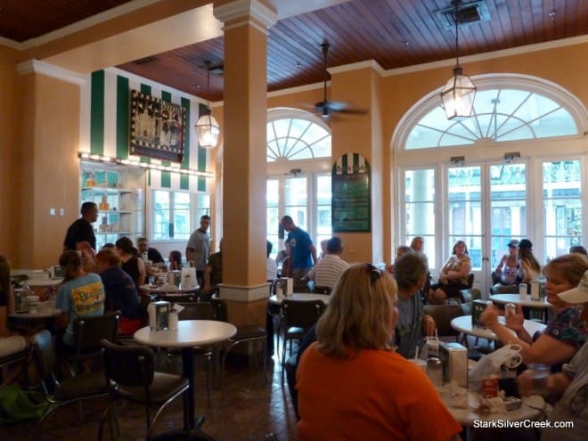 Indoor Dining Café du Monde Indoor dining room at Café du Monde with round tables and guests
