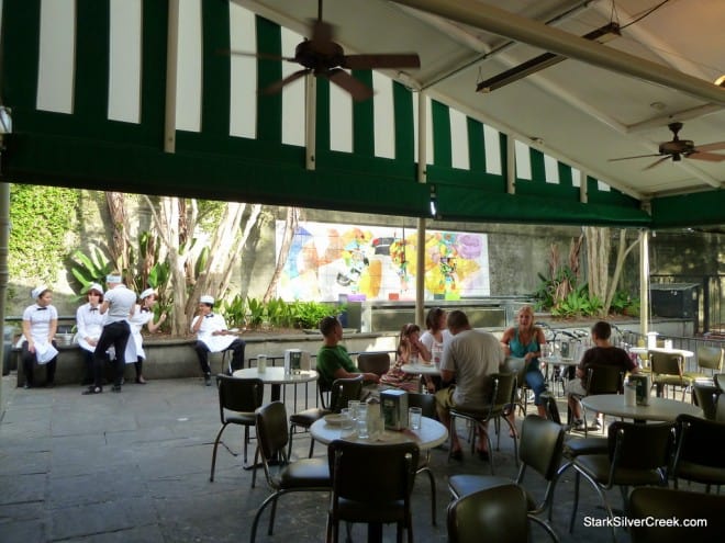 Outdoor Patio at Café du Monde Outdoor seating area under green and white awning in New Orleans