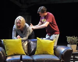 David (Gabriel Marin*) reluctantly gives Hannah (Carrie Paff*) a hormone shot in the National New Play Network Rolling World Premiere of Collapse
