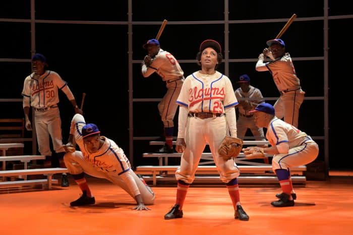 ‘Toni Stone’ (Dawn Ursula) speaks to the audience about her passion for baseball as a team assembles behind her in Lydia R. Diamond’s Toni Stone, performing at A.C.T.’s Geary Theater now through Sunday, March 29, 2020.