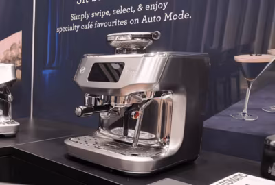 Wide shot of the Breville Oracle Dual Boiler espresso machine on a counter at a trade show
