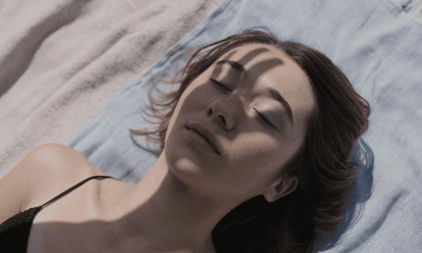 Zoe Stein as Cata in dappled sunlight in Forastera (2025), a Catalan drama about loss and a grandmother's lingering presence