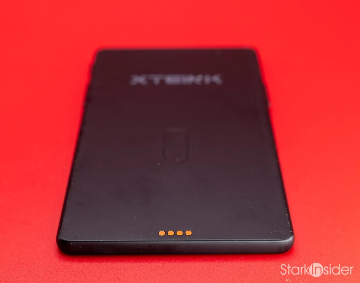 Back panel of the XTEINK X4 Pro showing the debossed XTEINK logo and the four gold pogo-pin charging contacts along the bottom edge