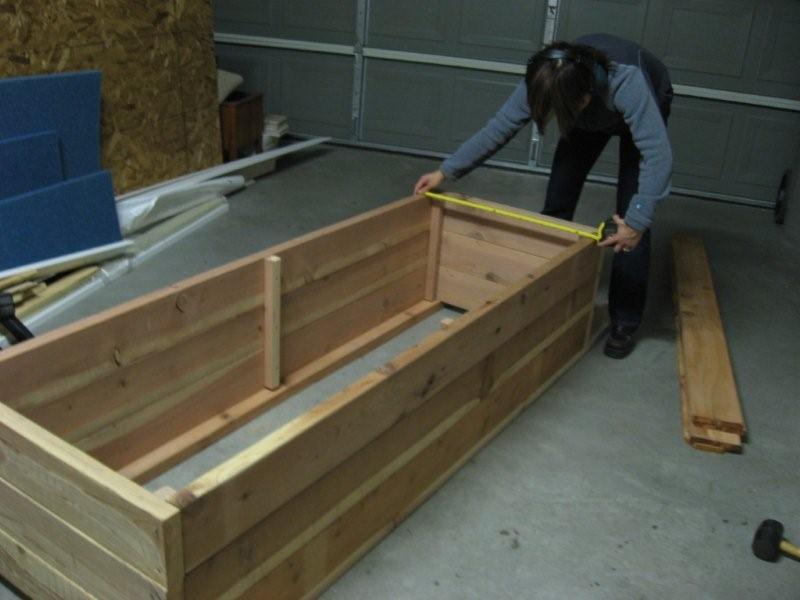 Measuring wood from Home Depot to build a planter box