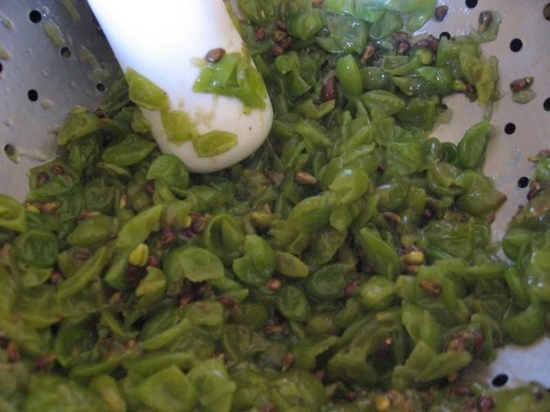 Grape Pulp and Seeds After Pressing Grape pulp and seeds in a strainer after pressing