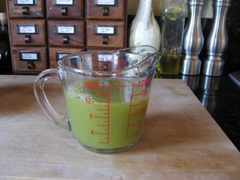 Fresh White Grape Juice Yield Green grape juice in a measuring cup on kitchen counter